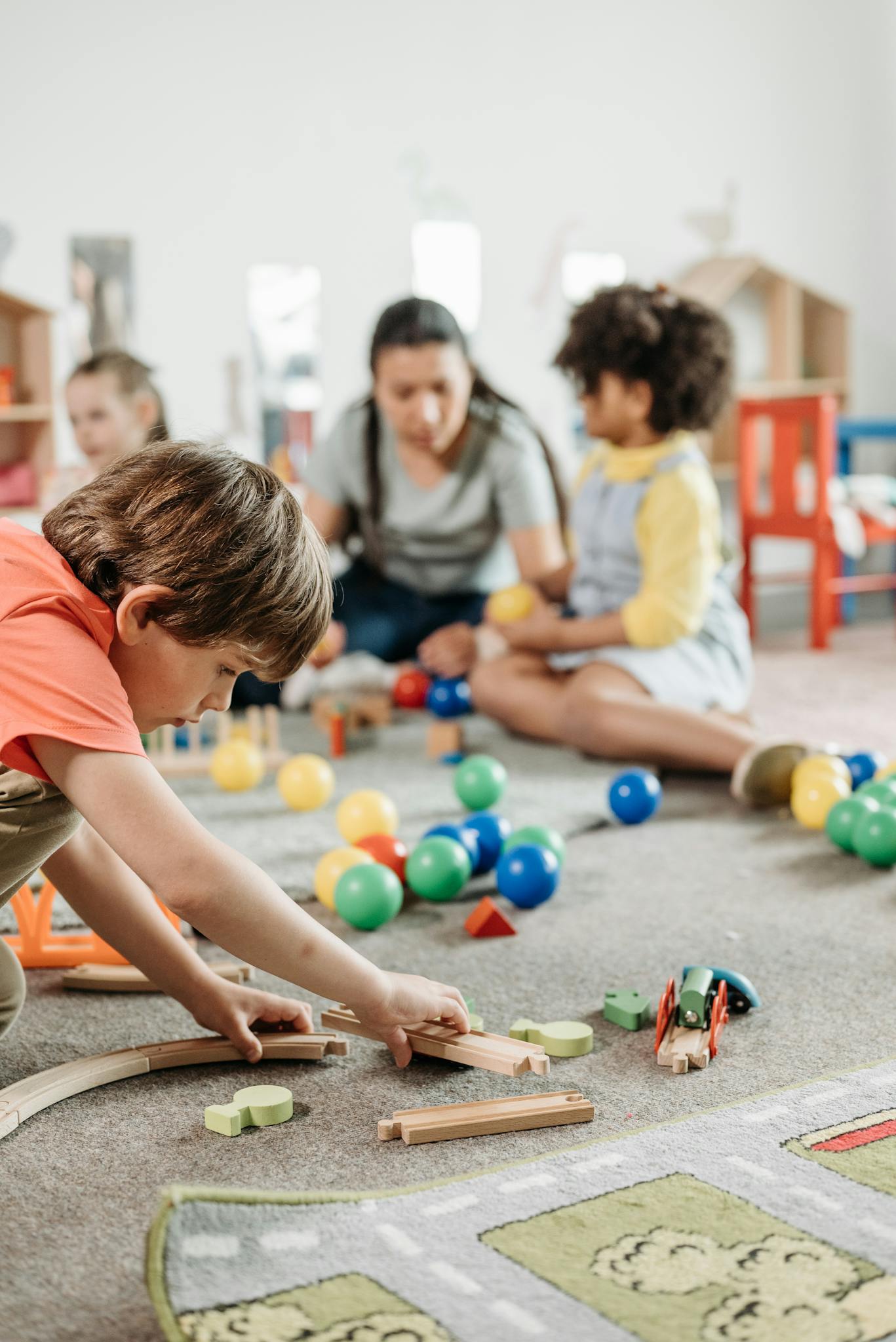 Children interacting with toys in a vibrant kindergarten setting, focusing on creativity and learning.